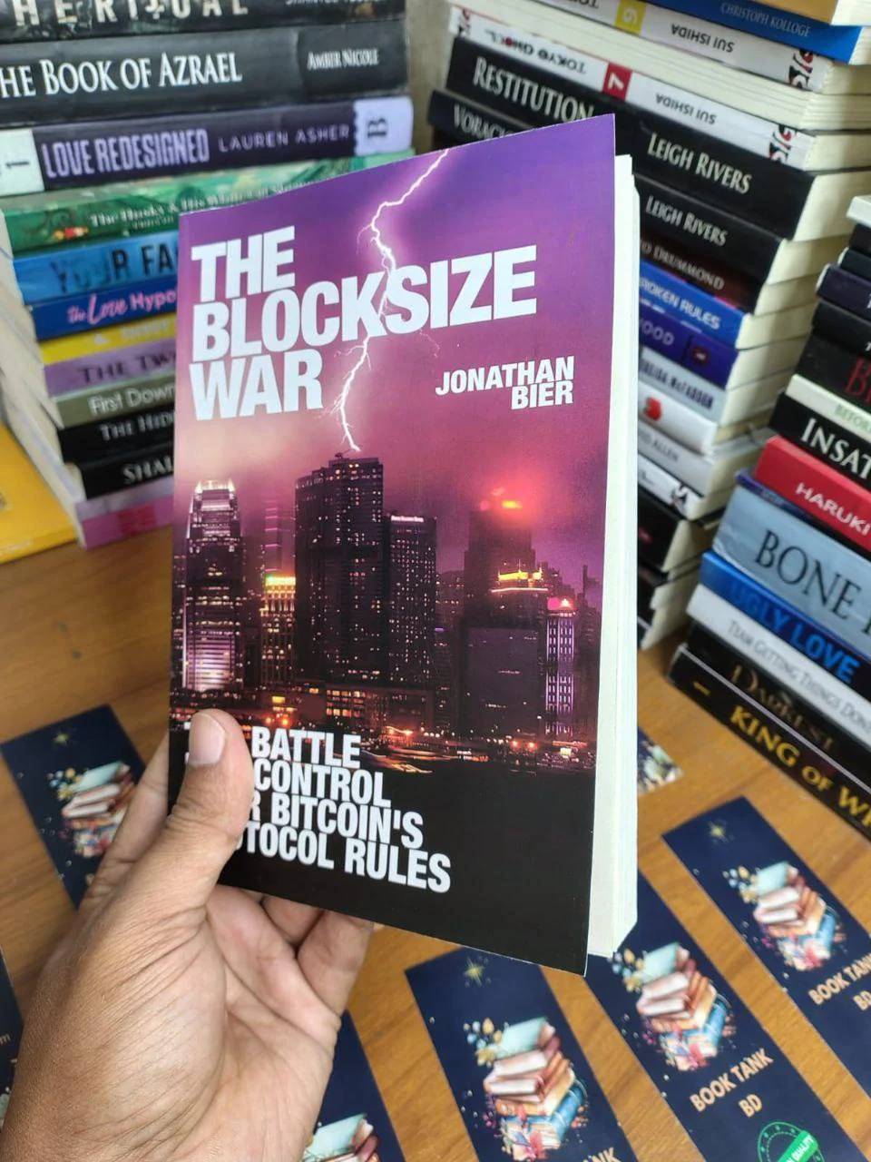 A hand holding the book 'The Blocksize War' by Jonathan Bier, a key piece of literature for anyone interested in Bitcoin nostalgia and the history of the protocol's governance.