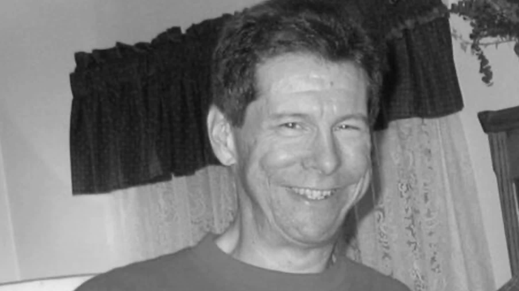 A black and white portrait of Hal Finney smiling. As the first person to receive a bitcoin transaction, he remains a central figure in bitcoin nostalgia and early crypto history.