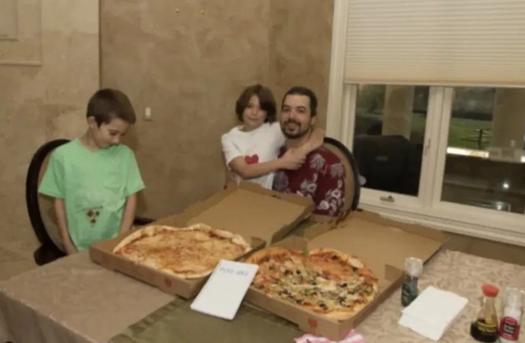 Laszlo Hanyecz sitting at a table with two large pizzas purchased for 10,000 Bitcoins in 2010, a key moment in bitcoin nostalgia history.
