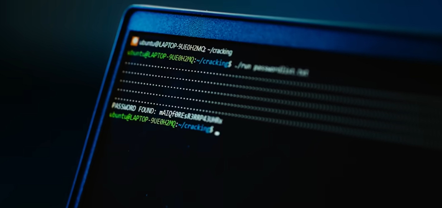 A close-up of a laptop screen running a Linux terminal script to brute force a Bitcoin wallet password, showing PASSWORD FOUND in green text, related to 2013 bitcoin nostalgia recovery.